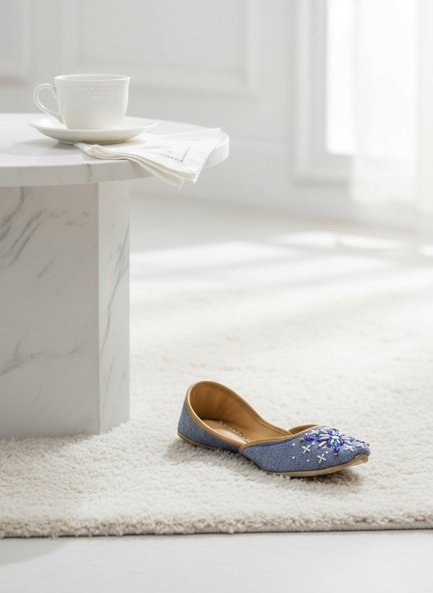 Ujaala blue denim-textured jutti with white, violet, and blue hand embroidery. Casual chic footwear.