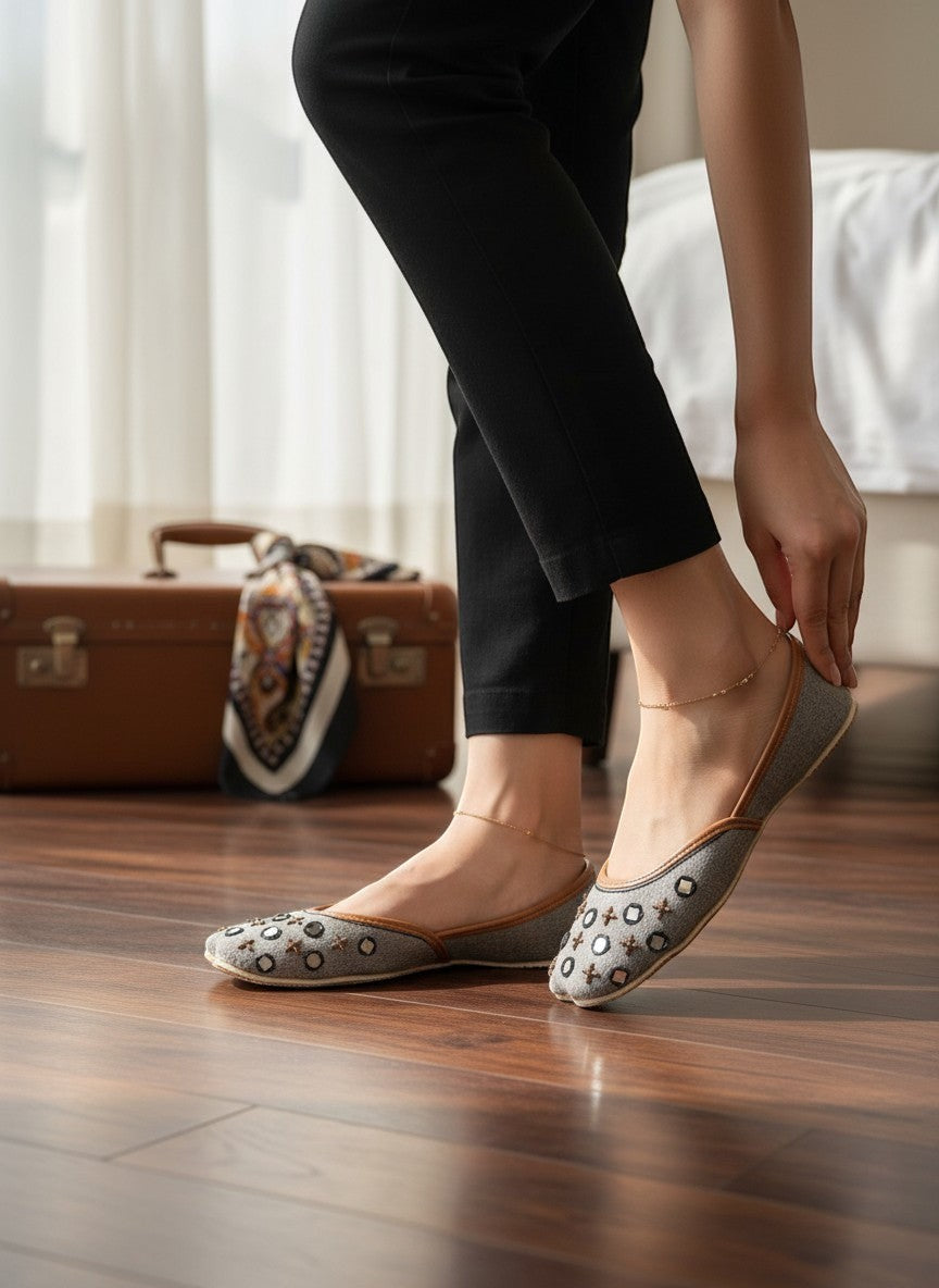 Ujaala Noor-e-Aab ash grey jutti with black and bronze mirror work embellishments and tan leather lining.