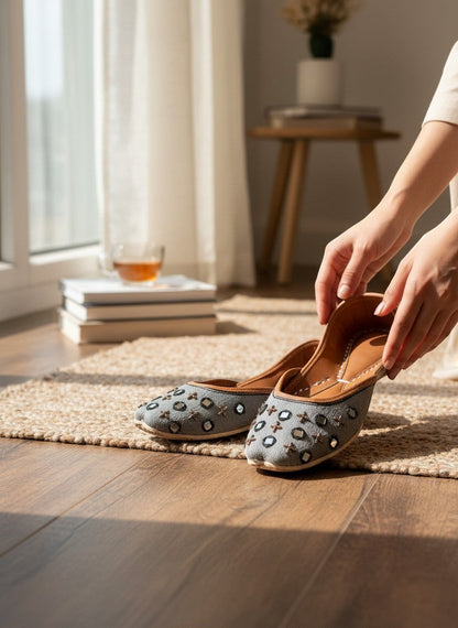 Ujaala Noor-e-Aab ash grey jutti with black and bronze mirror work embellishments and tan leather sole.