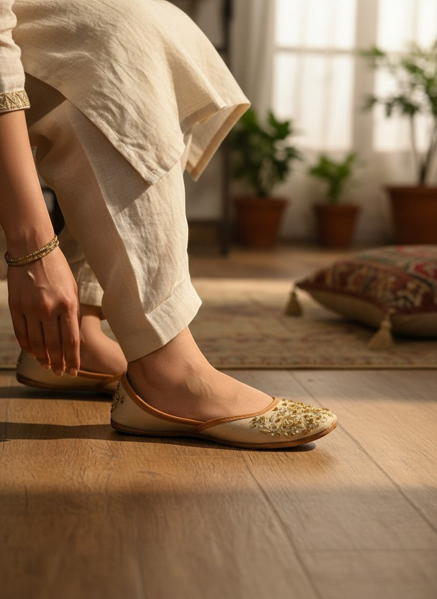 Ujaala beige jutti with intricate gold embroidery and beadwork on the toe.