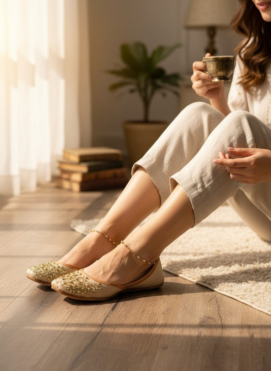 Ujaala beige jutti with intricate gold embroidery and bead embellishments on the toe.
