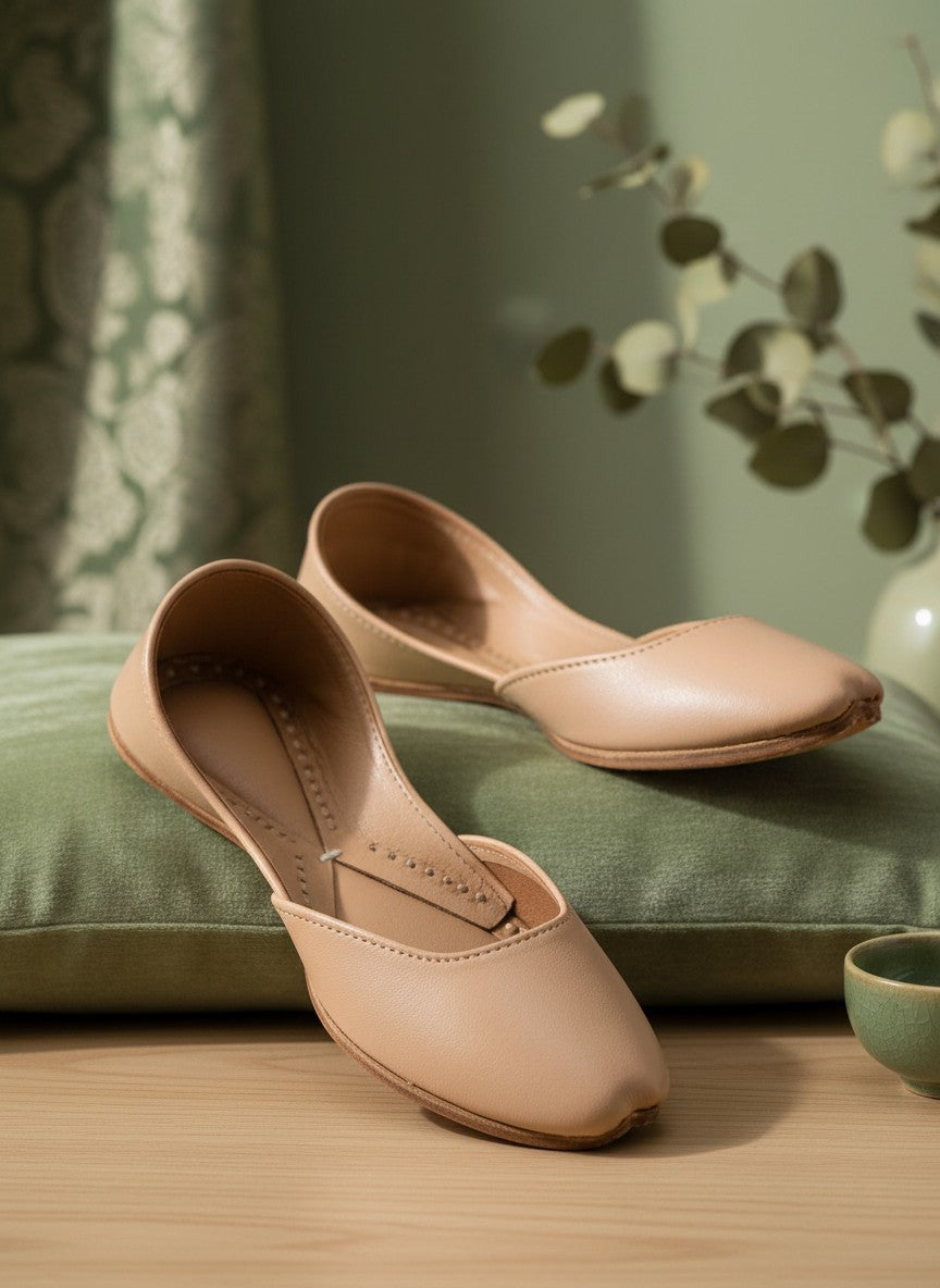 Ujaala Noora beige plain leather jutti with a pointed toe and stitched detailing.