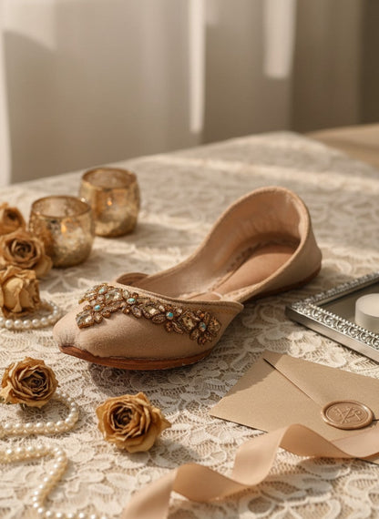 Ujaala Aarya beige velvet jutti adorned with intricate mirror diamond work and gold embroidery.