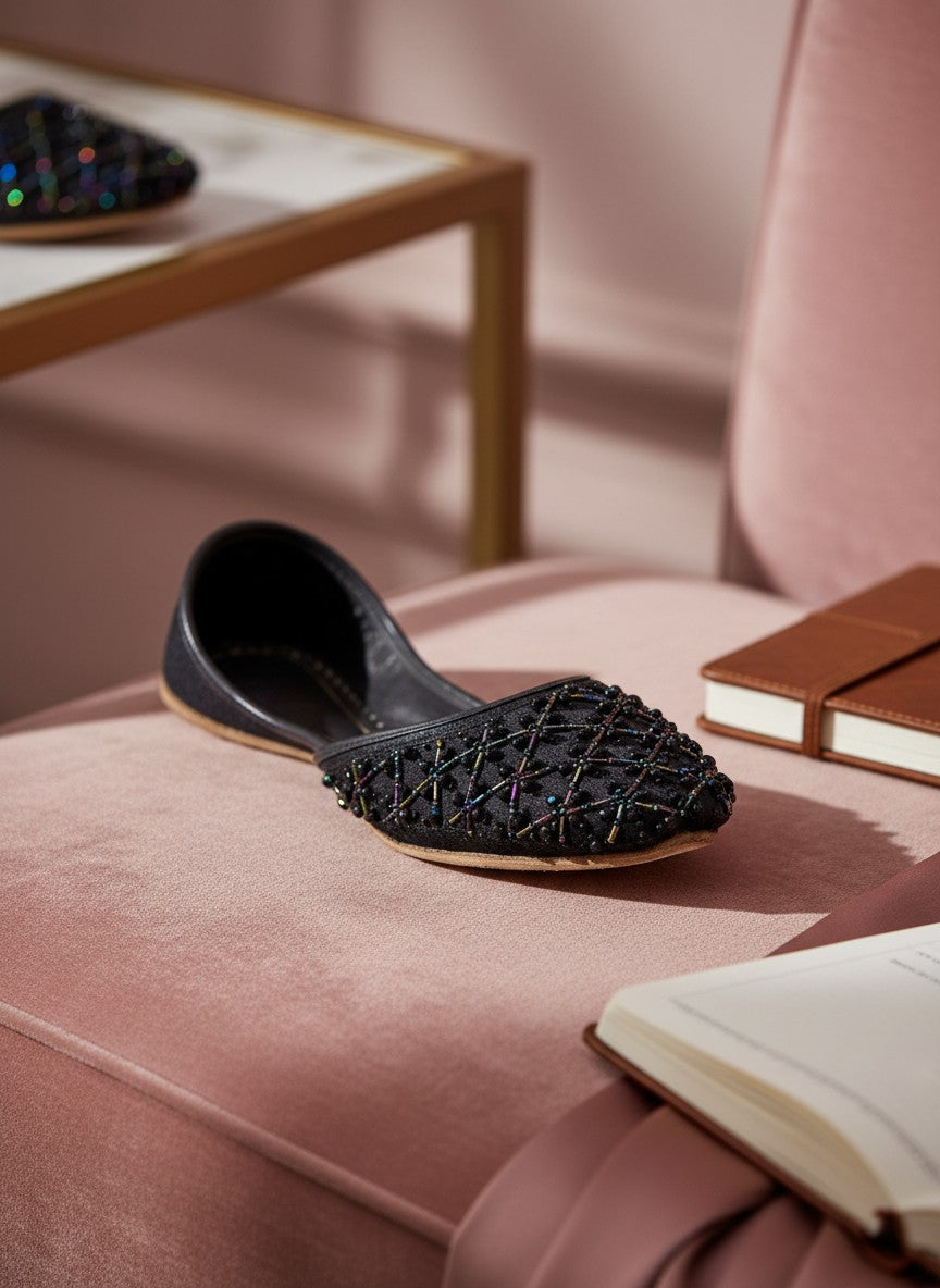 Ujaala black jutti with intricate black beadwork lattice pattern, perfect for formal events and festive styling.