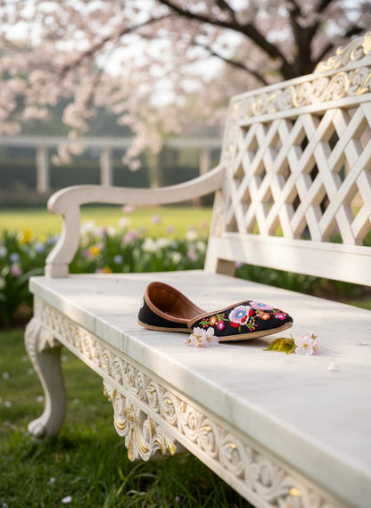 Ujaala Rangrez black handcrafted khussa with vibrant floral embroidery and bead detailing.