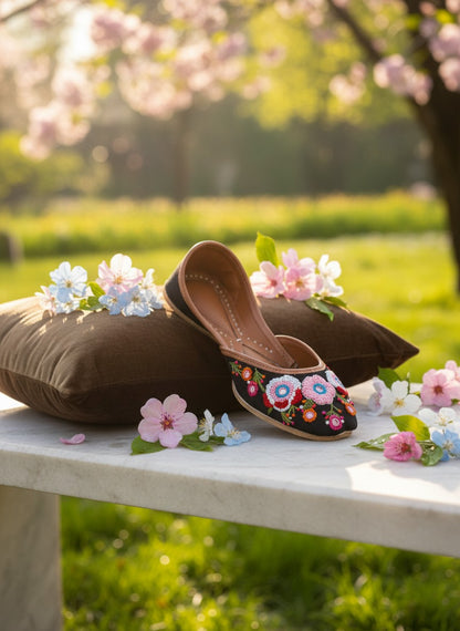 Ujaala Rangrez black handcrafted khussa with vibrant floral embroidery and bead detailing.