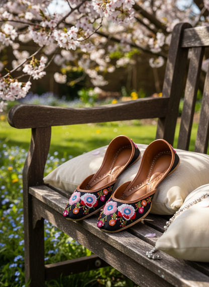 Ujaala Rangrez black handcrafted khussa with vibrant floral embroidery and bead detailing.