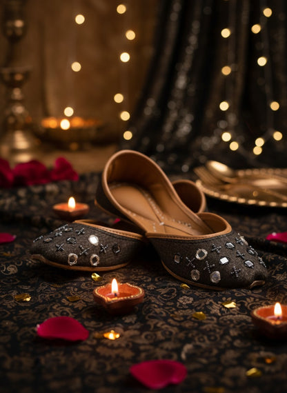 Ujaala Zarqa black cotton jutti with mirror and bead embellishments and a leather sole.
