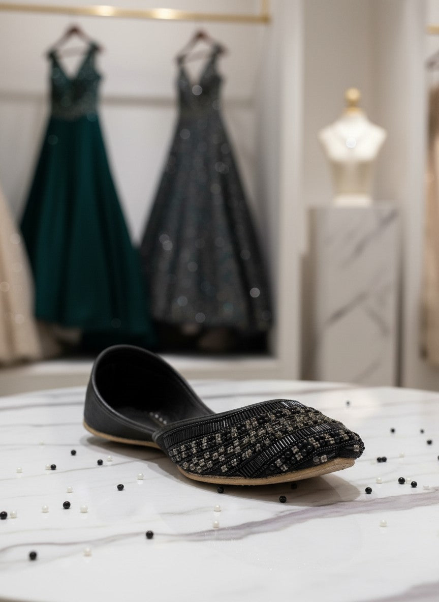 Ujaala Siyahi black jutti flats with intricate black beadwork and crystal detailing on the toe.