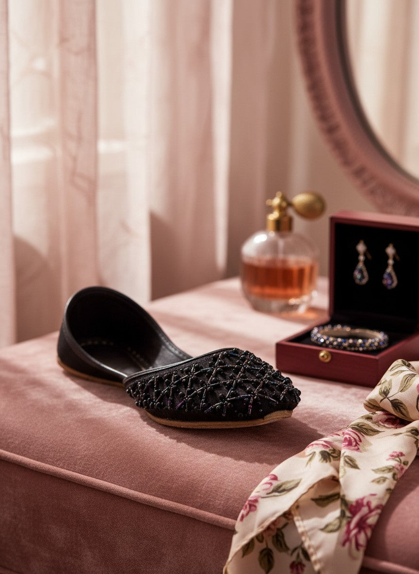 Ujaala Raani black jutti with intricate black beadwork lattice pattern, perfect for festive occasions.