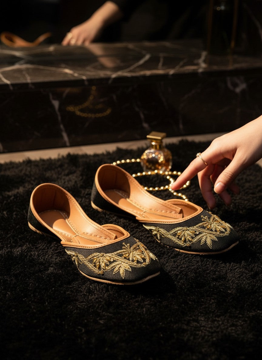 Ujaala Raqs black velvet juttis with gold embroidery and tan leather lining.