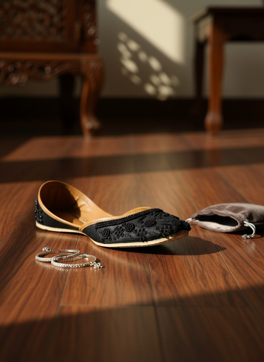 Ujaala Mausam black jutti with intricate floral bead embroidery and tan leather lining.