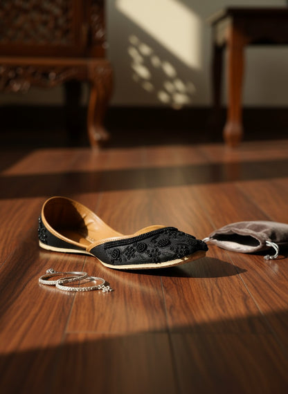 Ujaala Mausam black jutti with intricate floral bead embroidery and tan leather lining.