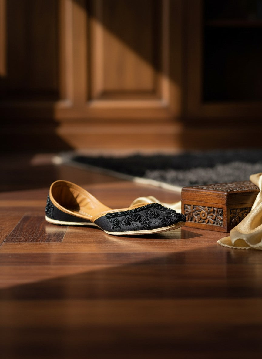 Ujaala Mausam black jutti with intricate floral bead embroidery and tan leather lining.