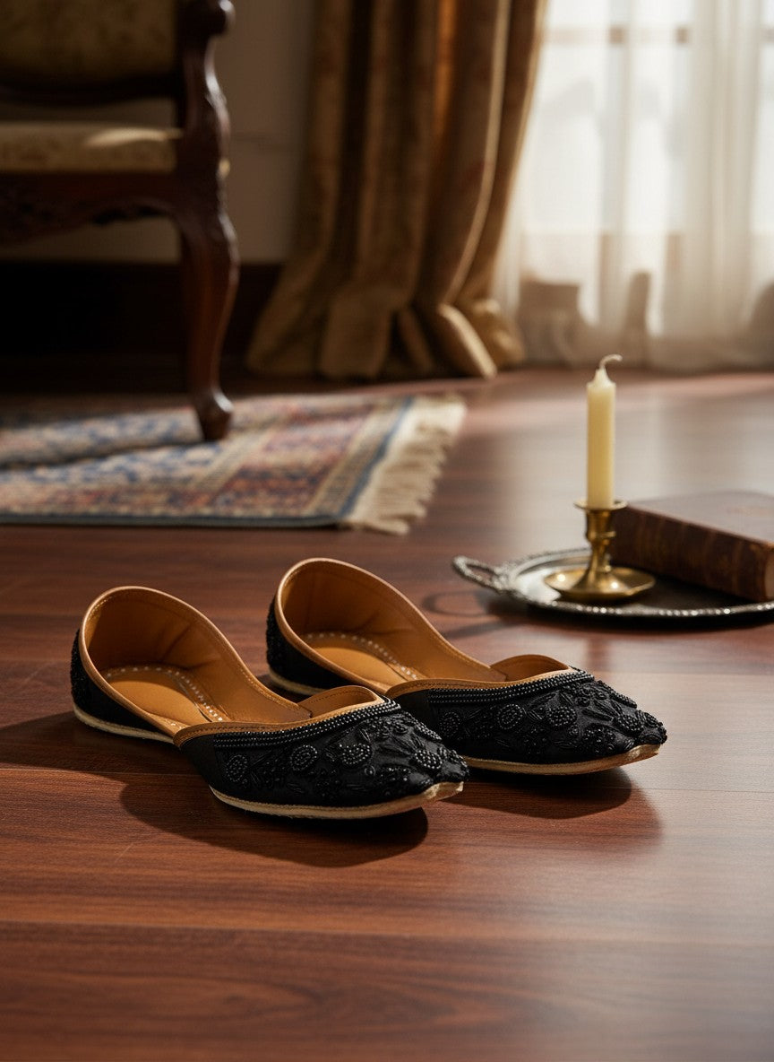 Ujaala Mausam black jutti with intricate floral bead embroidery and tan leather lining.