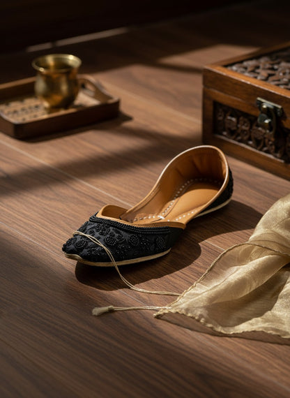 Ujaala Mausam black jutti with intricate floral bead embroidery and tan leather lining.