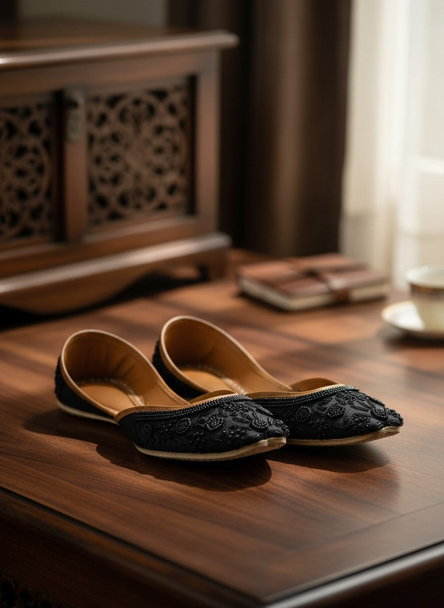 Ujaala Mausam black jutti with intricate floral bead embroidery and tan leather lining.