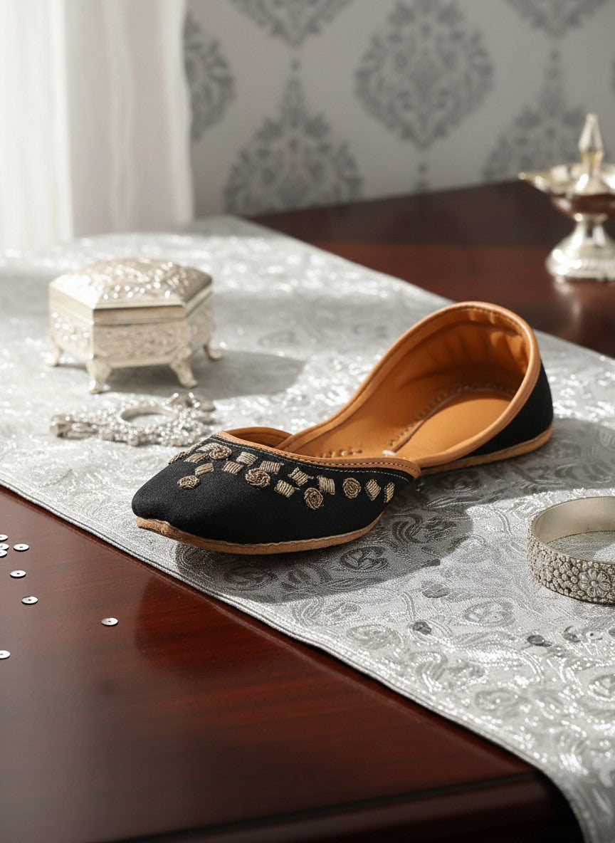 Ujaala black jutti with gold floral embroidery and tan leather lining. Handcrafted.