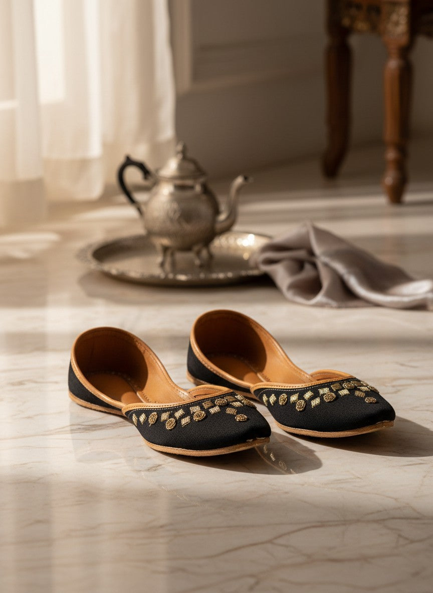 Ujaala black jutti with gold floral embroidery and tan leather lining.
