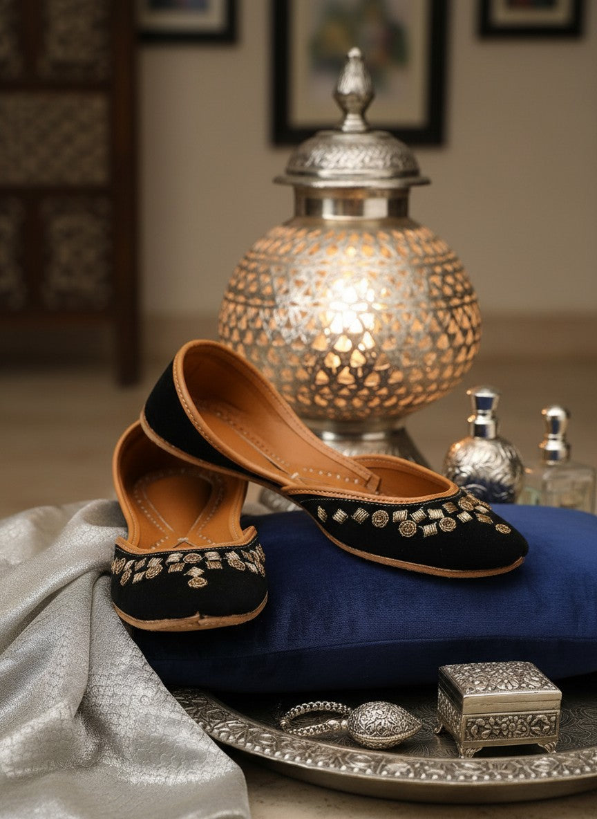 Ujaala black jutti with gold floral embroidery and tan leather lining.