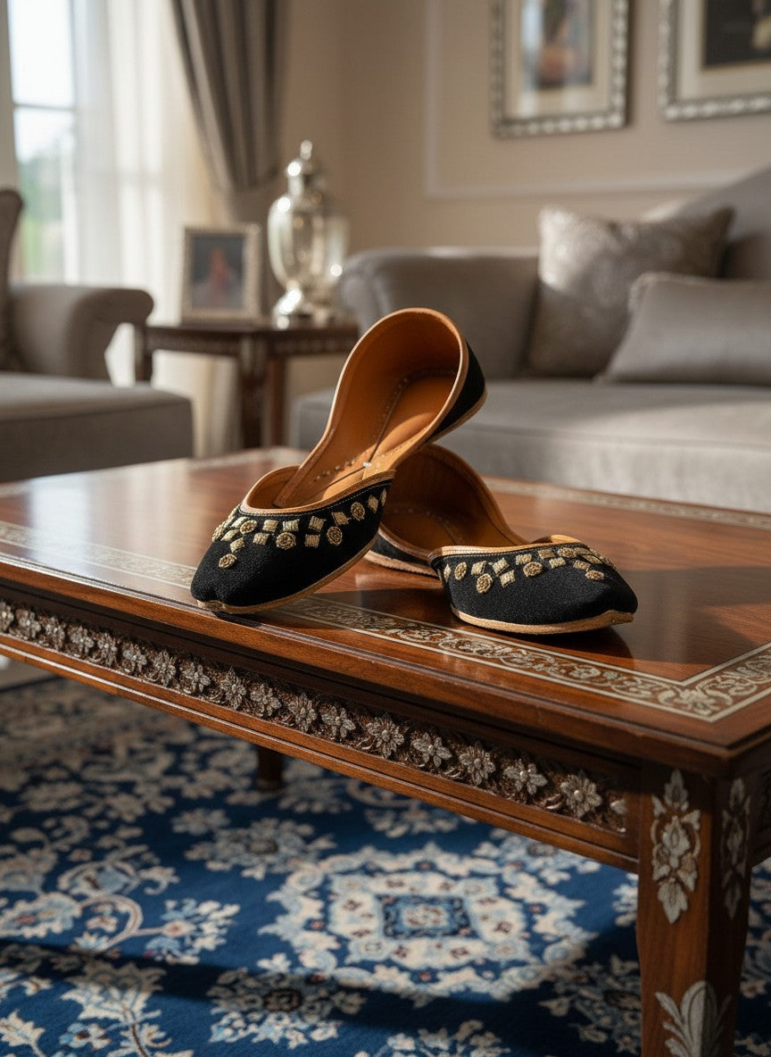 Ujaala black jutti with gold floral embroidery and tan leather lining.