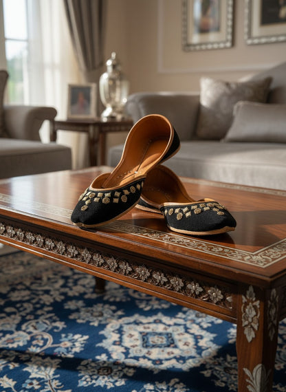 Ujaala black jutti with gold floral embroidery and tan leather lining.