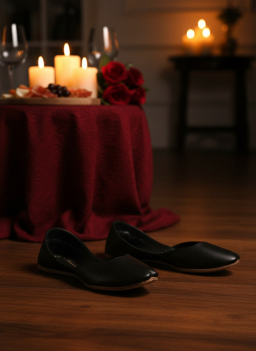 Ujaala Noora black plain leather jutti with a pointed toe and comfortable slip-on design.