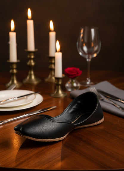 Ujaala Noora black plain pure leather jutti with a pointed toe and stitched sole.