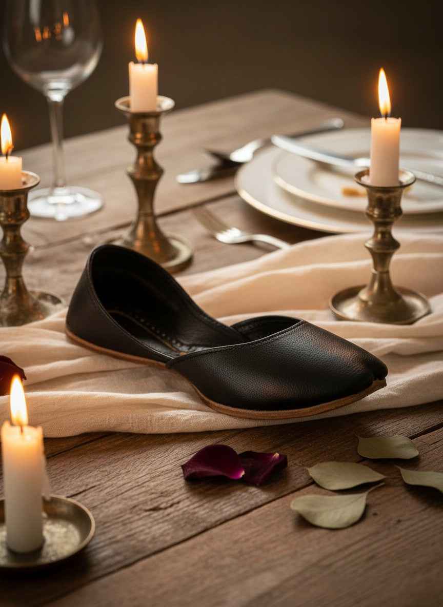 Ujaala Noora black plain leather jutti with a pointed toe and low heel.