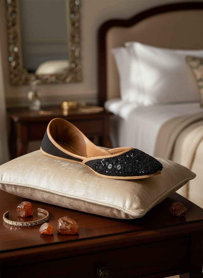 Ujaala black jutti embellished with black sequins and beads, featuring a tan leather lining and sole.