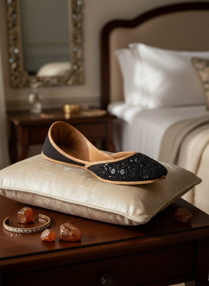 Ujaala black jutti embellished with black sequins and beads, featuring a tan leather lining and sole.