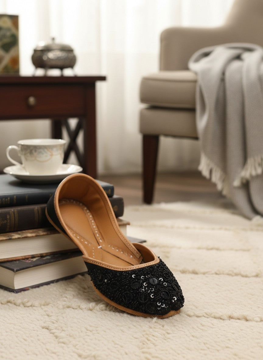 Ujaala black jutti embellished with black sequins and beads, featuring a tan leather lining and sole.