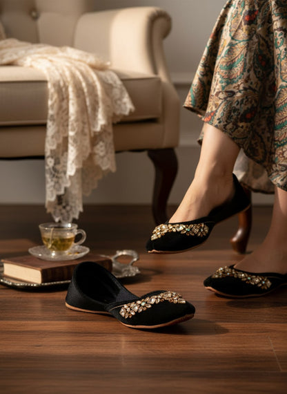 Ujaala black velvet jutti with intricate mirror diamond work embellishment on the toe.