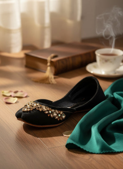 Ujaala black velvet jutti with intricate mirror diamond work on the toe.