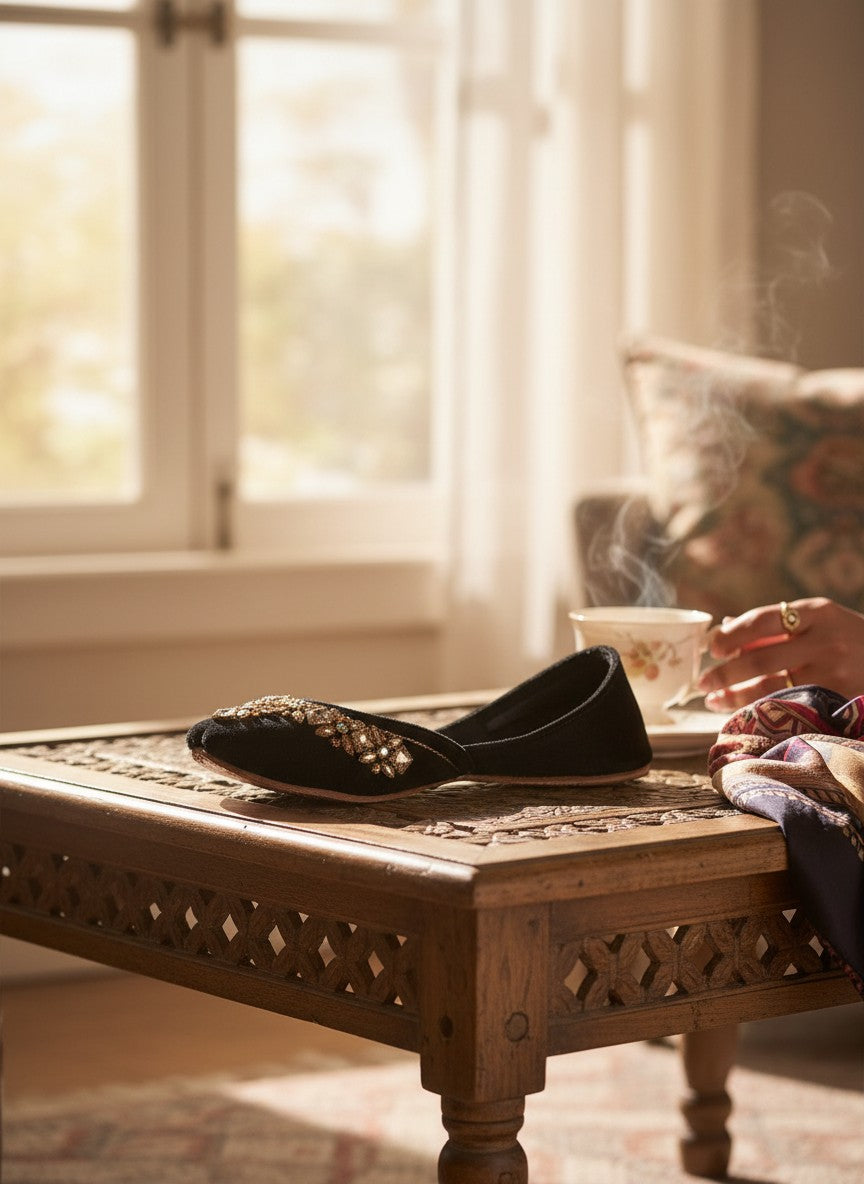 Ujaala black velvet jutti with intricate mirror diamond work on the toe.