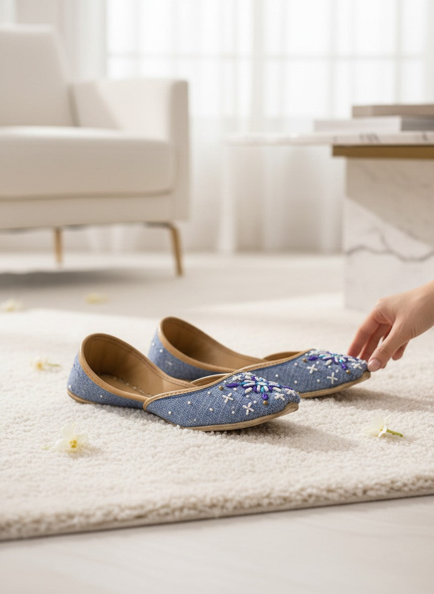 Ujaala Sathi blue denim-textured jutti with white, violet, and blue hand embroidery. Perfect for casual chic or daytime desi style.
