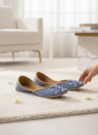 Ujaala Sathi blue denim-textured jutti with white, violet, and blue hand embroidery. Perfect for casual chic or daytime desi style.
