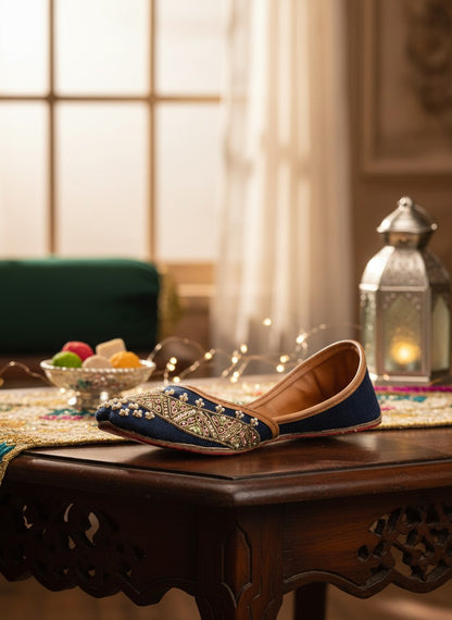 Ujaala Badshah blue jutti embellished with gold thread, pearls, and pink beads. Traditional South Asian footwear.