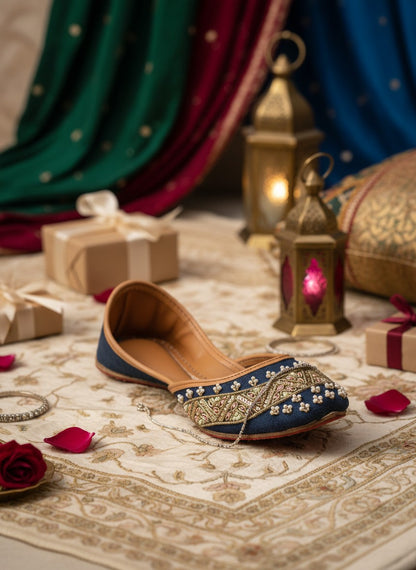 Ujaala Badshah blue jutti embellished with gold thread, pearls, and pink beads. Traditional South Asian footwear.