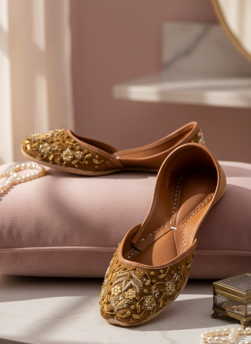 Ujaala brown suede jutti with intricate gold and bead embroidery. Traditional Indian flat shoe.