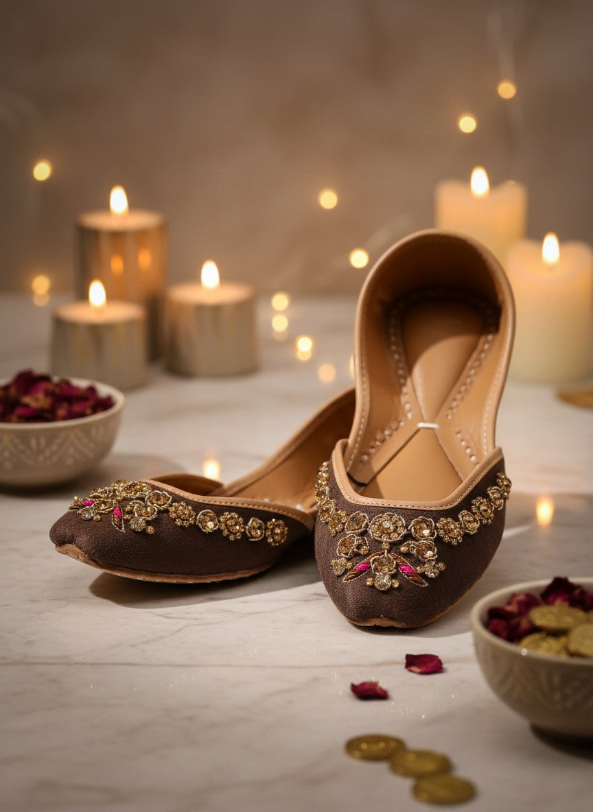 Ujaala brown suede Punjabi juttis for women with intricate gold and pink bead embroidery. Flat sole, almond toe.