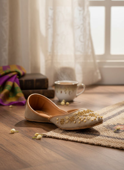 Ujaala Taj Talab brown suede jutti with gold floral embroidery and pearl bead embellishments.