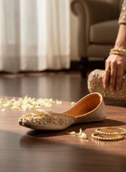 Ujaala brown suede jutti with intricate gold floral embroidery and pearl bead embellishments.