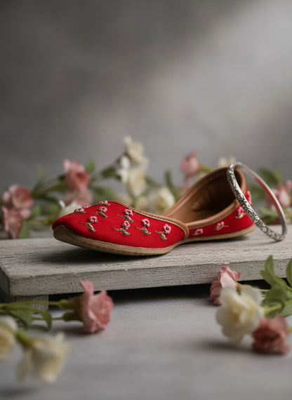 Ujaala Gulaab Cherry Jutti: Red embroidered flat shoes with floral detail and comfortable construction.