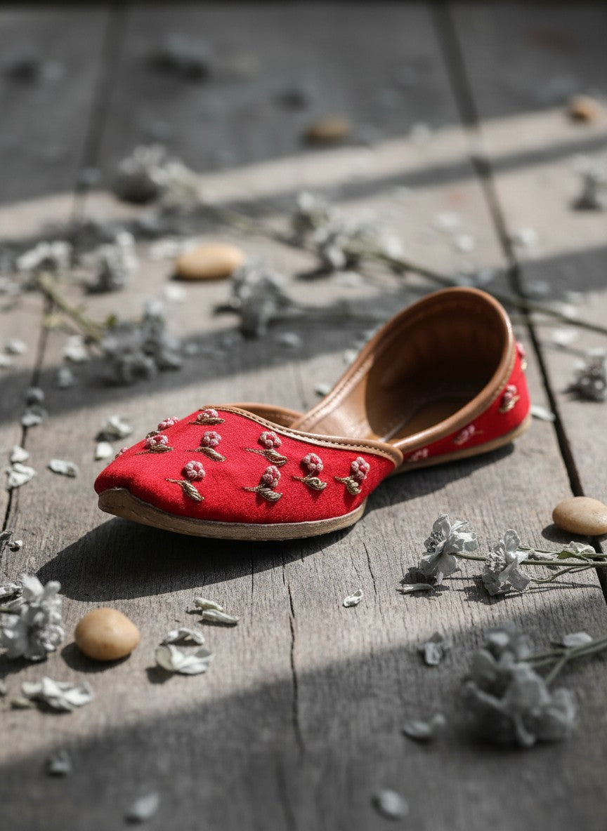 Ujaala Gulaab Cherry Jutti: Red embroidered flat shoes with floral details and comfortable construction.