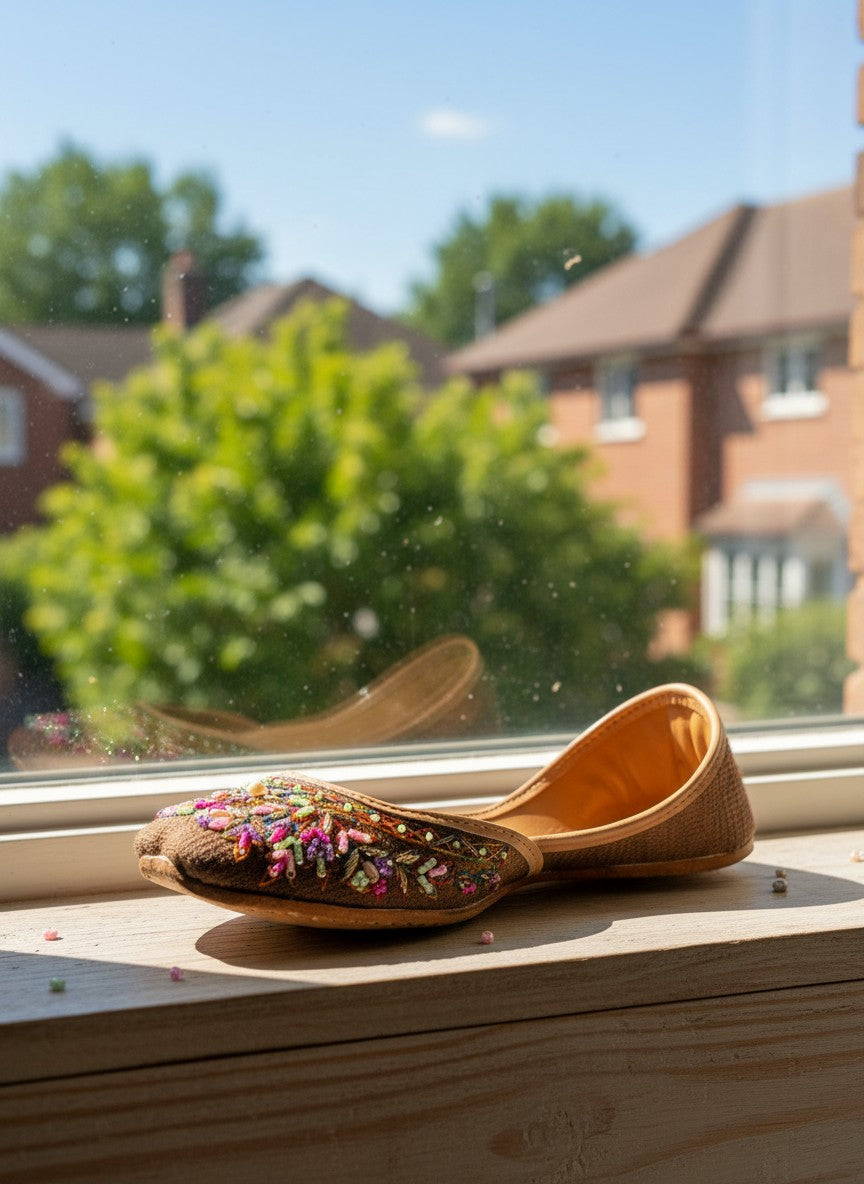 Ujaala deep chocolate brown jutti with intricate multi-colored bead and thread embroidery on the toe.