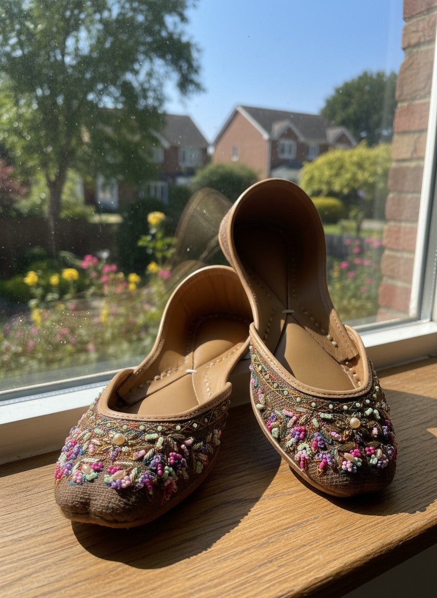 Ujaala deep chocolate brown jutti with intricate multi-colored bead and thread embroidery on the toe.
