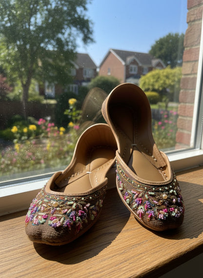 Ujaala deep chocolate brown jutti with intricate multi-colored bead and thread embroidery on the toe.