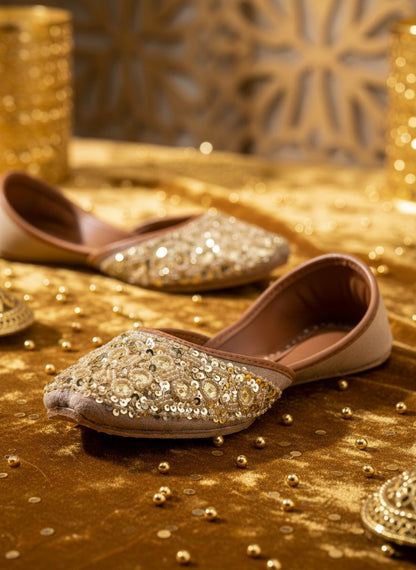 Ujaala gold jutti adorned with circular sequins and beads. Elegant flat shoes for women.
