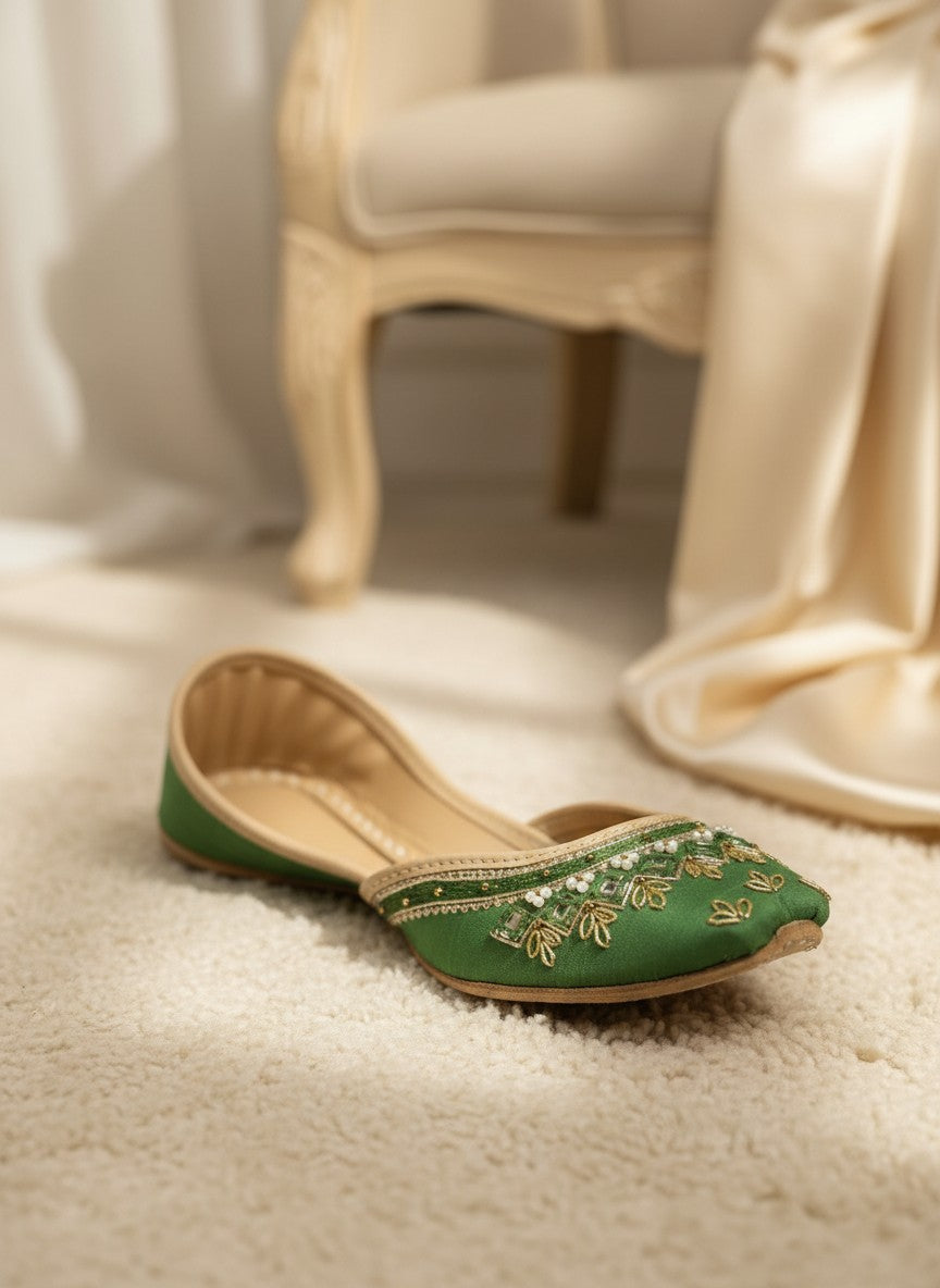 Ujaala green silk jutti with gold embroidery and pearl embellishments, traditional Indian flat shoes.